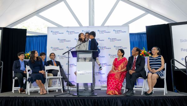 Tampa business leader and philanthropist Sidd Pagidipati holds his children while announcing a transformative $50 million donation to St. Joseph's Children's Hospital Foundation.
