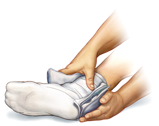 Closeup of hands holding ice pack around ankle. Sock is covering foot and ankle.