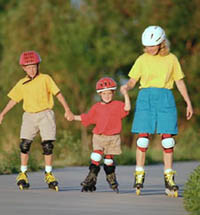 Picture of a family, wearing helmets, rollerblading