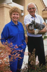 Picture of man and woman outside with dog