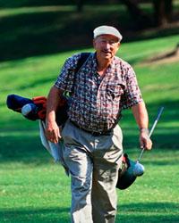 Picture of an elderly man with his golf clubs