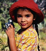 Picture of a young girl with a camera, smiling