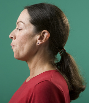 Side view of woman's head showing pursed-lip breathing.