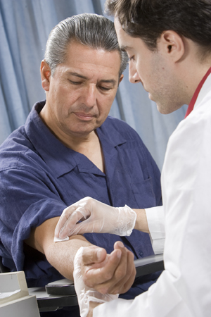 Man having his blood drawn by healthcare provider.