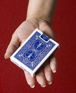 Hand holding a deck of cards.