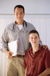 Doctor standing with teen boy