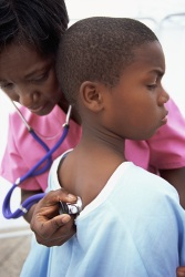 Boy being examined by nurse
