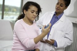 Doctor insturcts teen on inhaler use