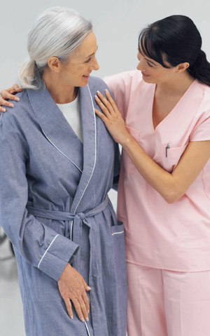 Health care provider walking with senior patient.