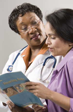 Female doctor and patient looking at patient workbook.