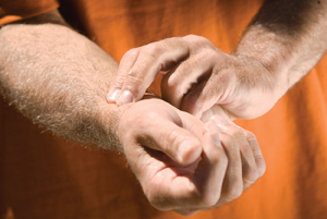 Close-up of man checking his pulse rate in his wrist.
