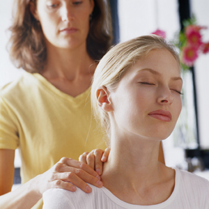 A woman having a neck and shoulder massage.