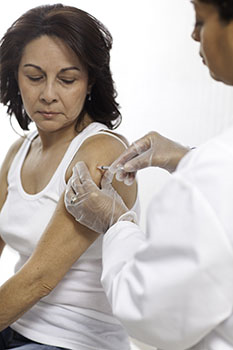 Woman getting a shot in her upper arm