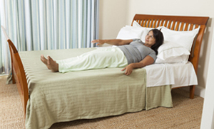 Woman rolling on to her side in bed.