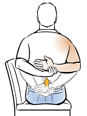 Man sitting in chair doing internal rotation shoulder exercise.