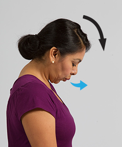 Woman breathing out while doing head tilt exercise.