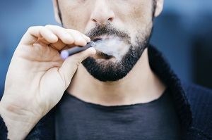 Man using e-cigarette