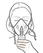 Woman inhaling medication through nebulizer facemask on face.