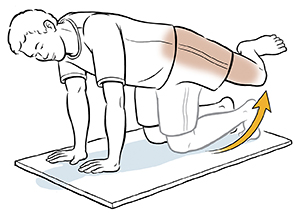 Man on all fours doing hip abduction exercise.