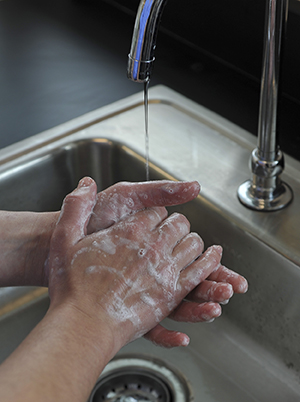 Closeup of handwashing in sink.
