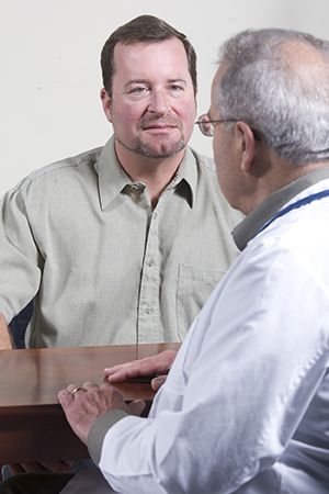 Man in consultation with a healthcare provider.