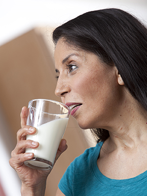 Woman drinking glass of milk.