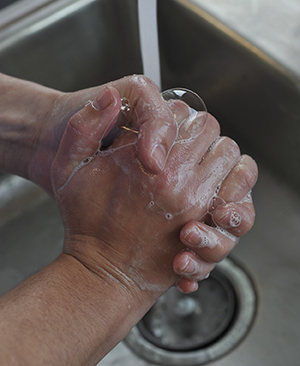 Closeup of handwashing in sink.