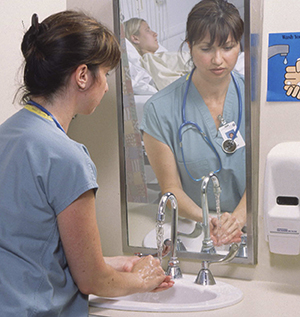 Healthcare provider washing hands.