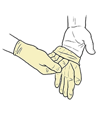 Gloved hand pulling sterile glove onto fingers of opposite hand.