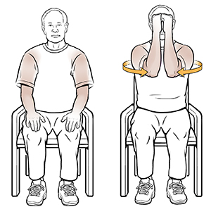 Man sitting in chair doing shoulder isometric exercise.