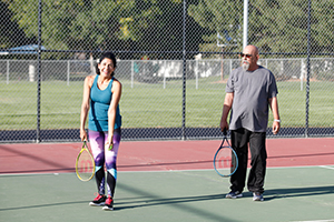 Man and woman playing tennis.