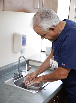 Health care provider washing hands.