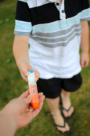 Anaphylaxis auto injector being given to a child.