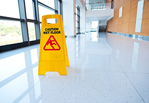 Yellow sign on floor cautioning wet floor.