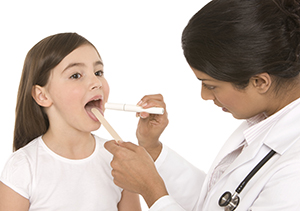Doctor looking at girl's throat