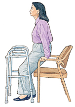 Woman holding onto chair arms instead of walker and getting ready to sit down.