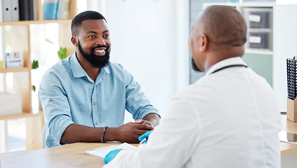 Doctor and patient conversing with one another.
