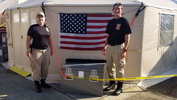 Jack and Patty standing in front of an american flag