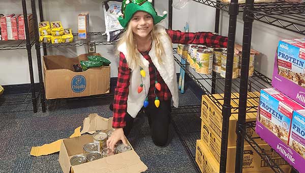 volunteer stocking shelves at Bardmoor Elementary food pantry
