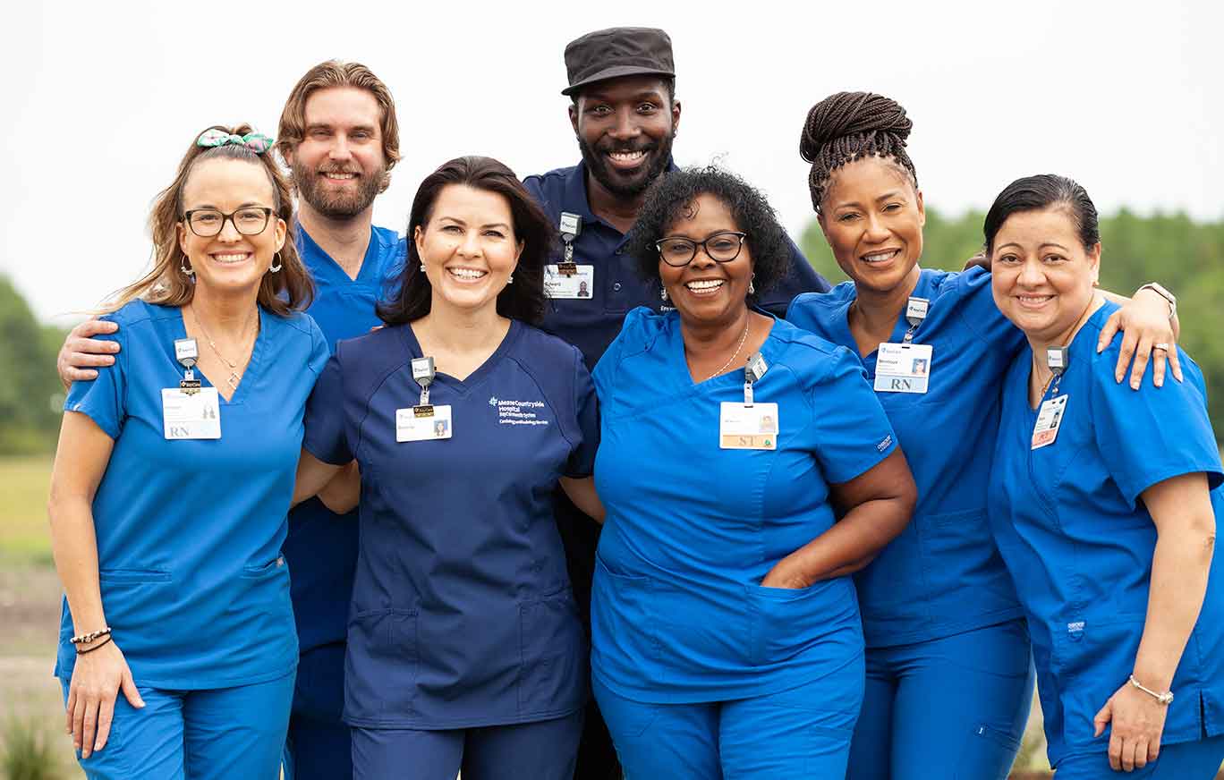 Diverse group of BayCare staff standing together for a photo