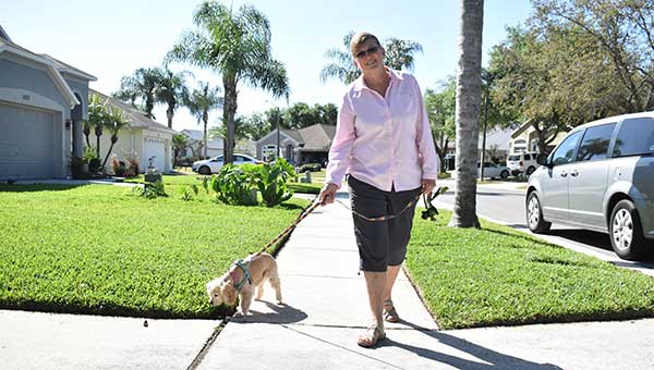 dianna bushaw walking her dog outside on a sunny day