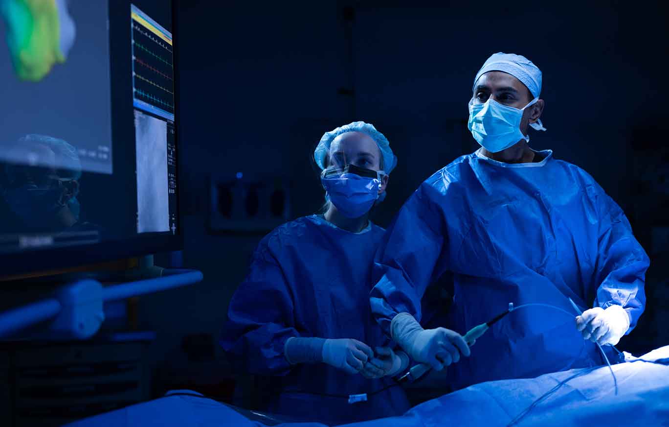 two cariac surgeons in scrubs inside operating room