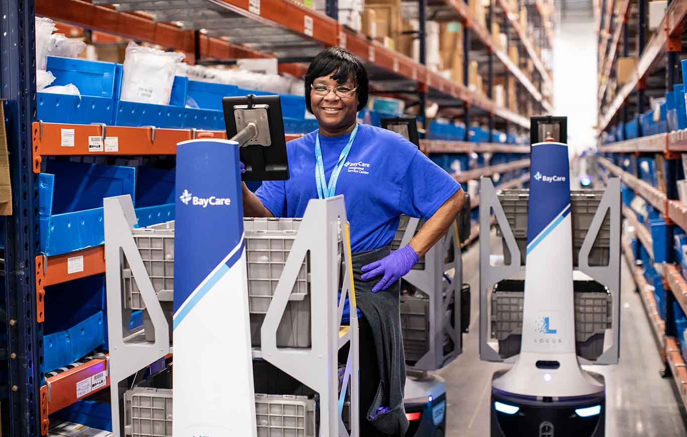 smiling baycare employee working in the bisc warehouse