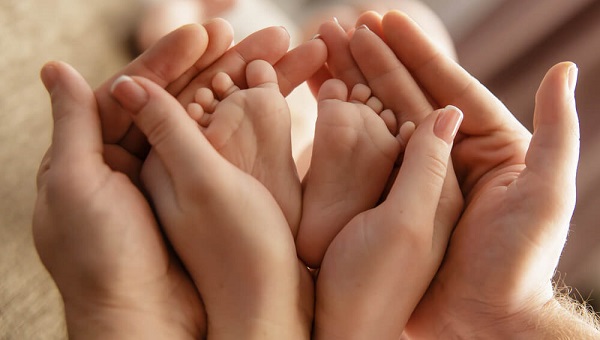 Baby feet in parent hands