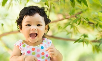 Baby girl happy and smile face with nature green background