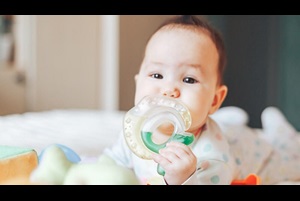 Baby chewing on a teething ring