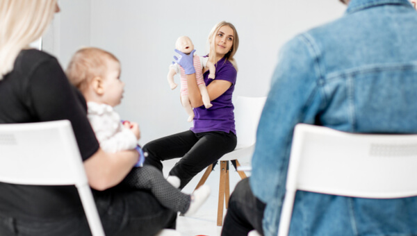a pregnant woman instructing a class