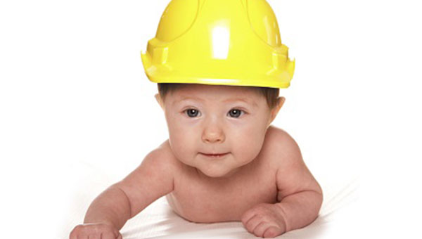 baby wearing a yellow construction hat