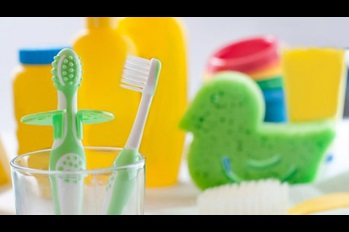 Closeup of baby's first toothbrushes in the bathroom