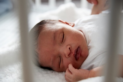 Newborn Baby Sleeping In Crib